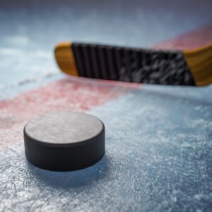 Hockey stick and puck on ice