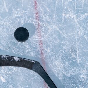 Puck and stick on frozen rink