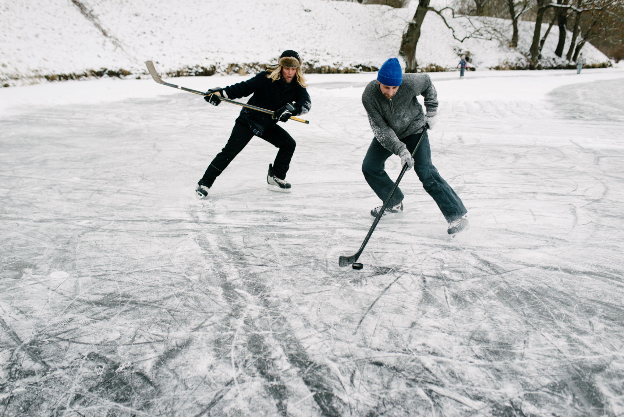 Snowy outdoor ice hockey match scene